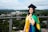 woman in academic dress and academic hat standing on green grass field during daytime