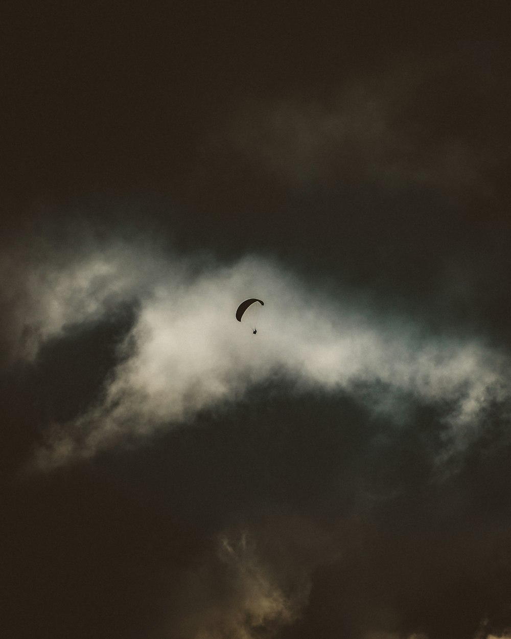 person in parachute in the sky