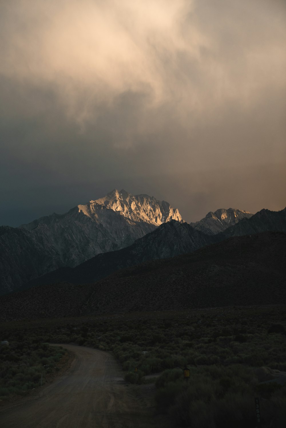 snow covered mountain under cloudy sky during daytime