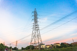 black electric tower under blue sky during daytime