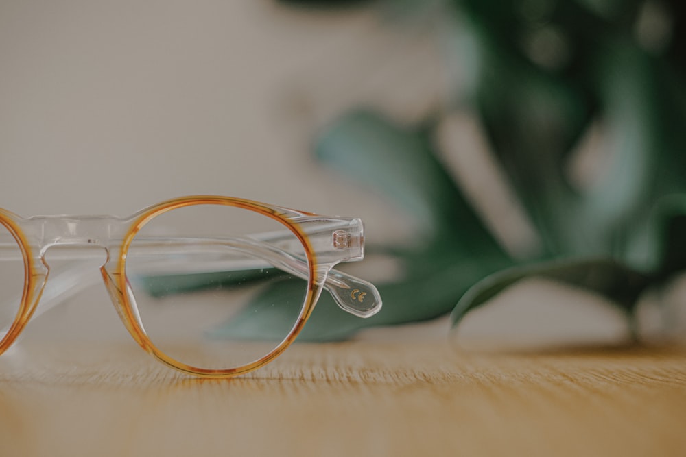 yellow framed eyeglasses on white textile