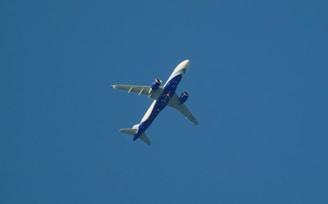 Photograph of planes flying against a clear blue sky, showcasing their flight paths.
