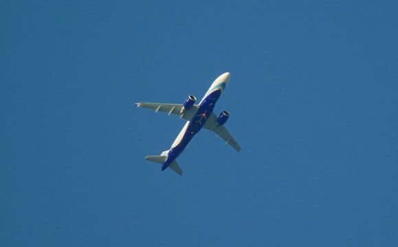 Photograph of planes flying against a clear blue sky, showcasing their flight paths.