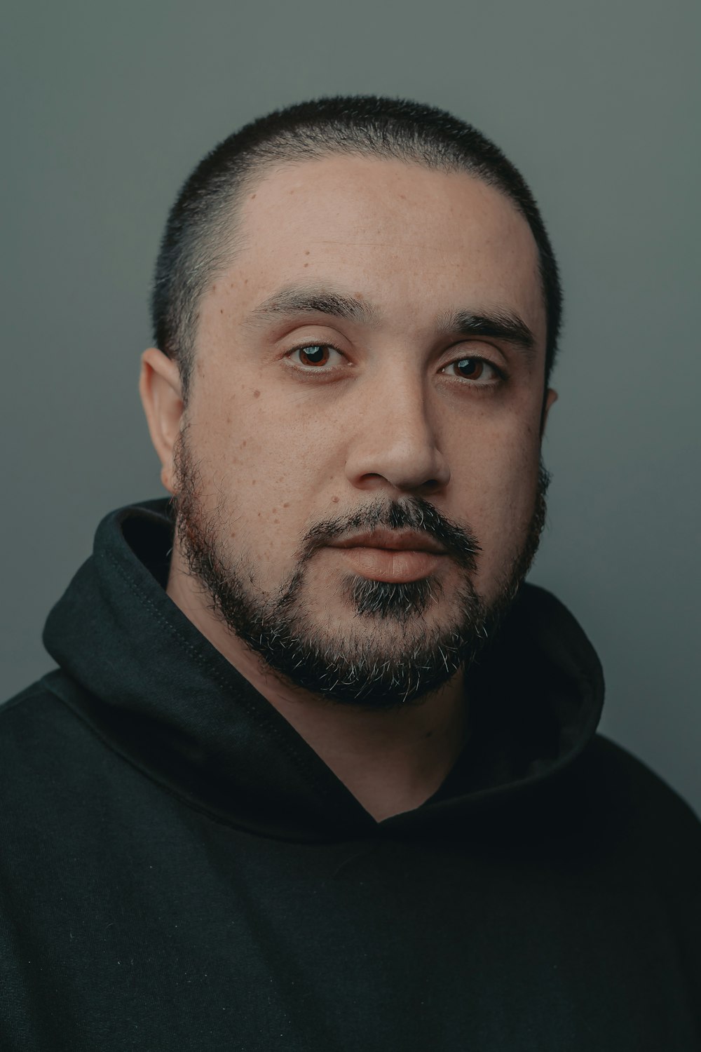 man in black hoodie taking selfie