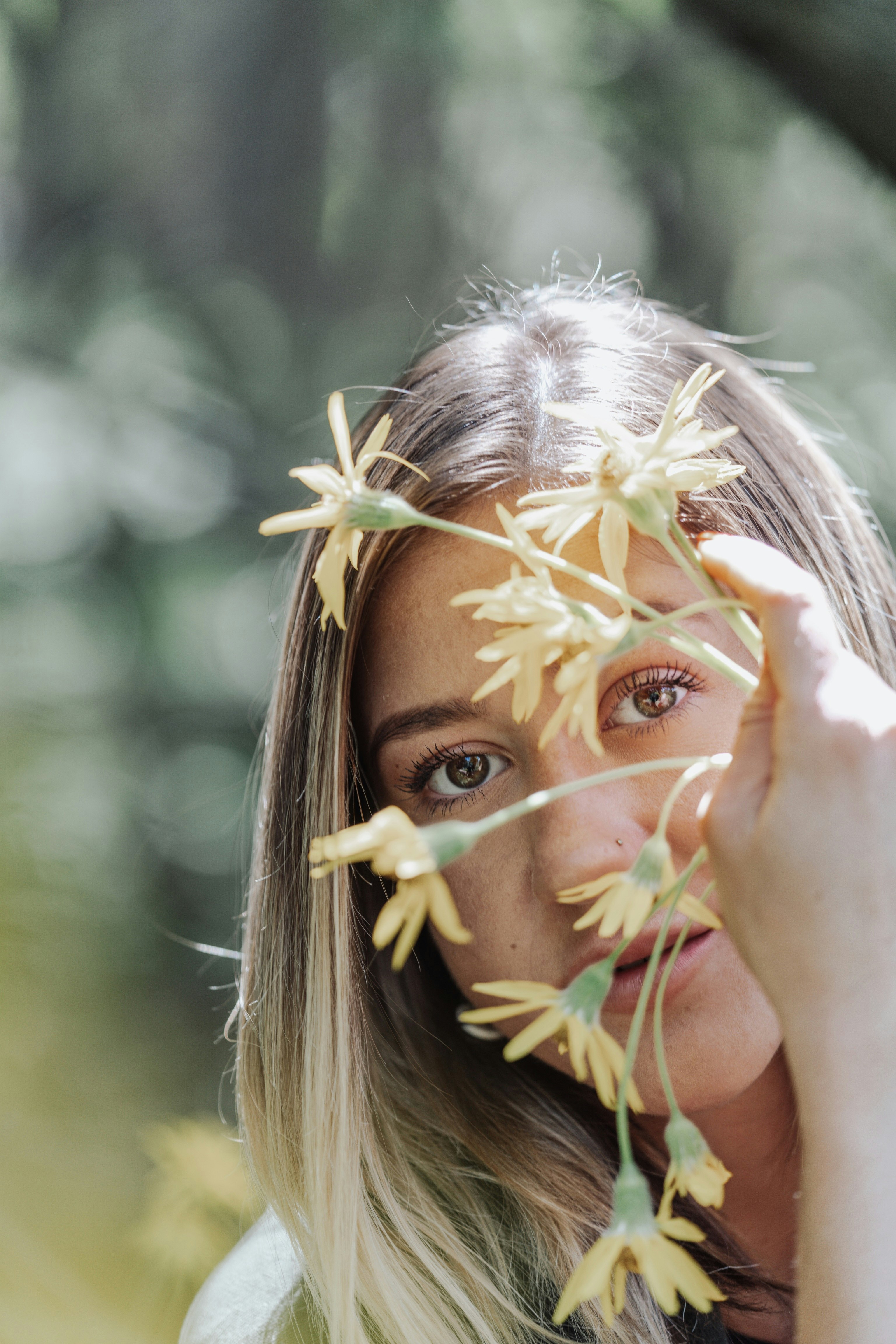 girl with blonde hair covering her face with her hands