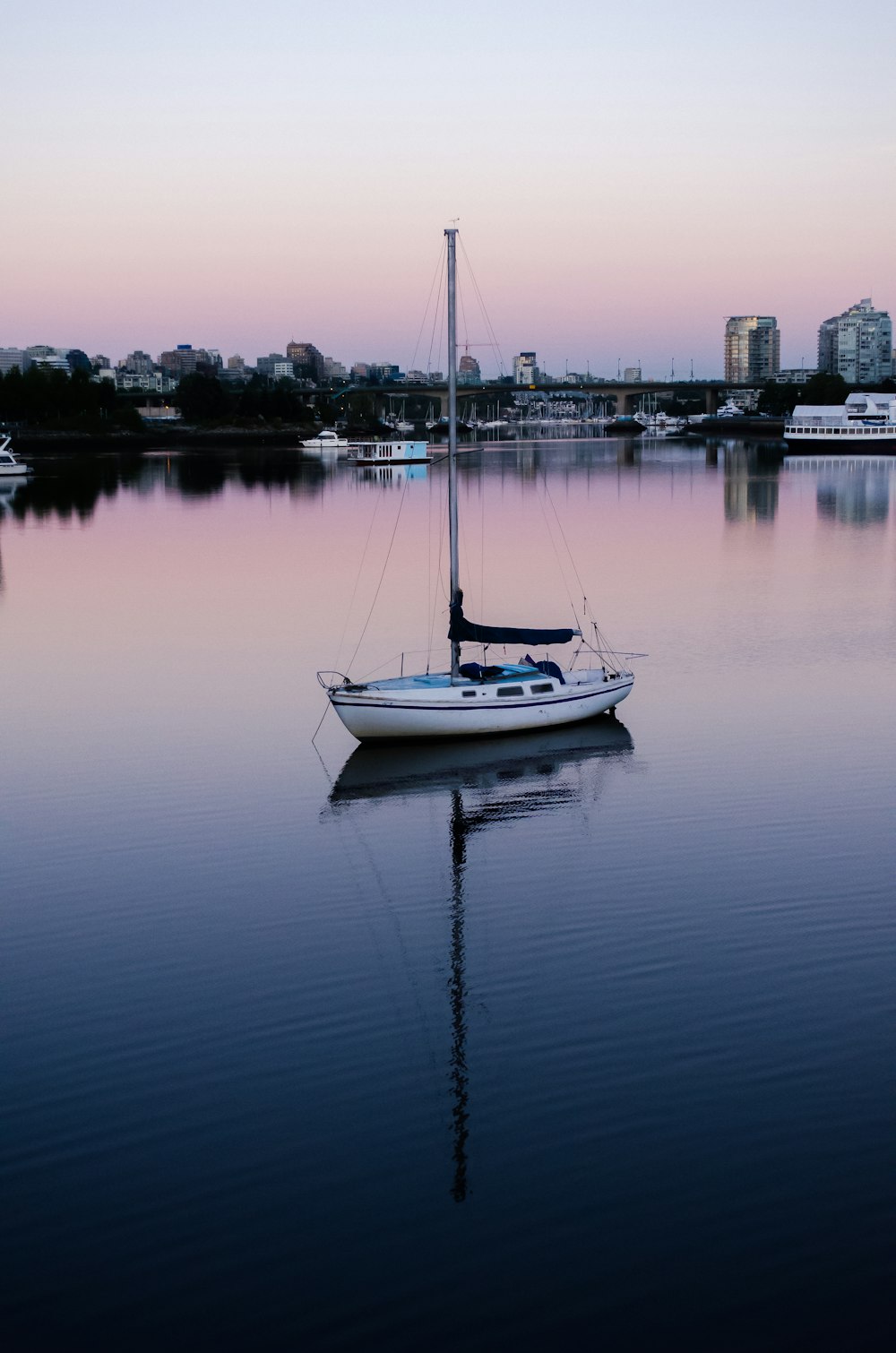 white boat on calm water during daytime