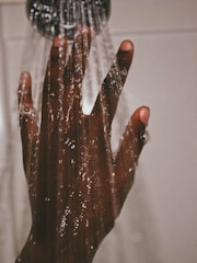 persons hand with silver ring