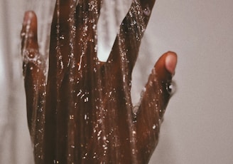 persons hand with silver ring