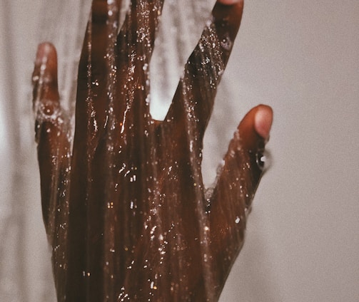 persons hand with silver ring