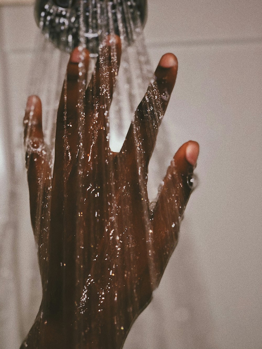 persons hand with silver ring