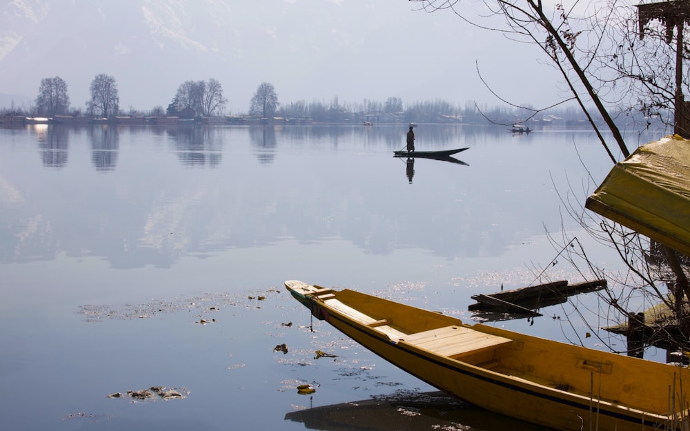 brown wooden boat on lake during daytime