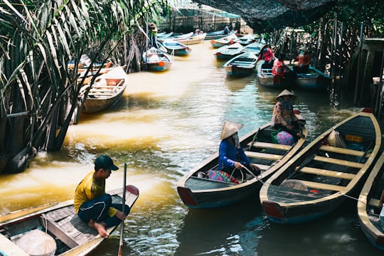 people riding on boat during daytime in Mỹ Tho Vietnam