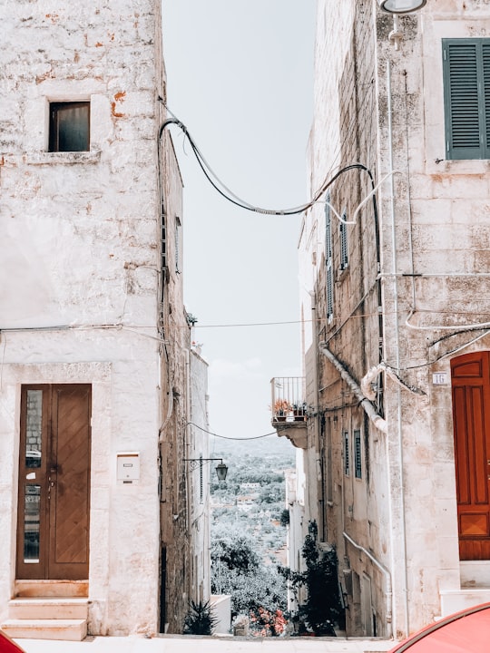 white and brown concrete building during daytime in Cisternino Italy