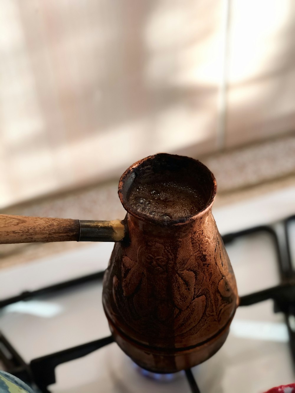 brown ceramic vase on white table