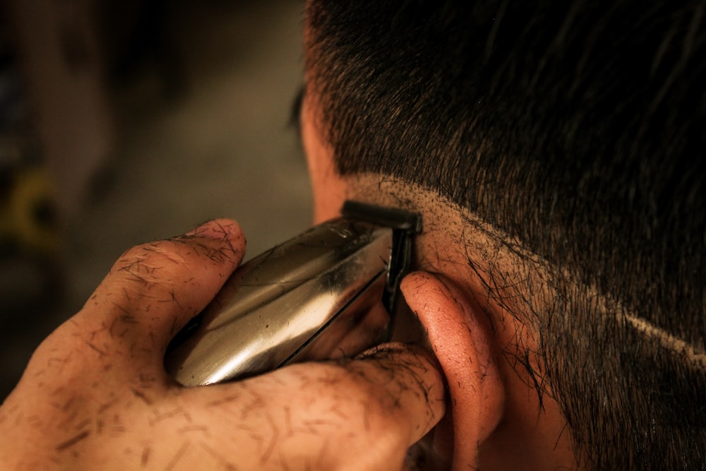 man holding black and silver tool