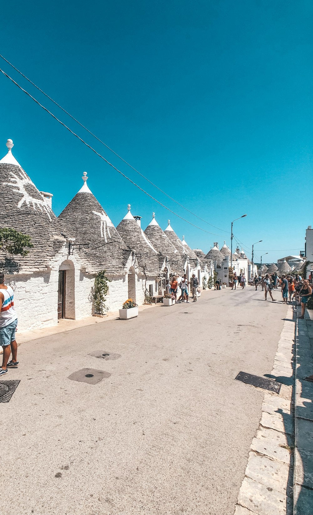 people walking on street near houses during daytime