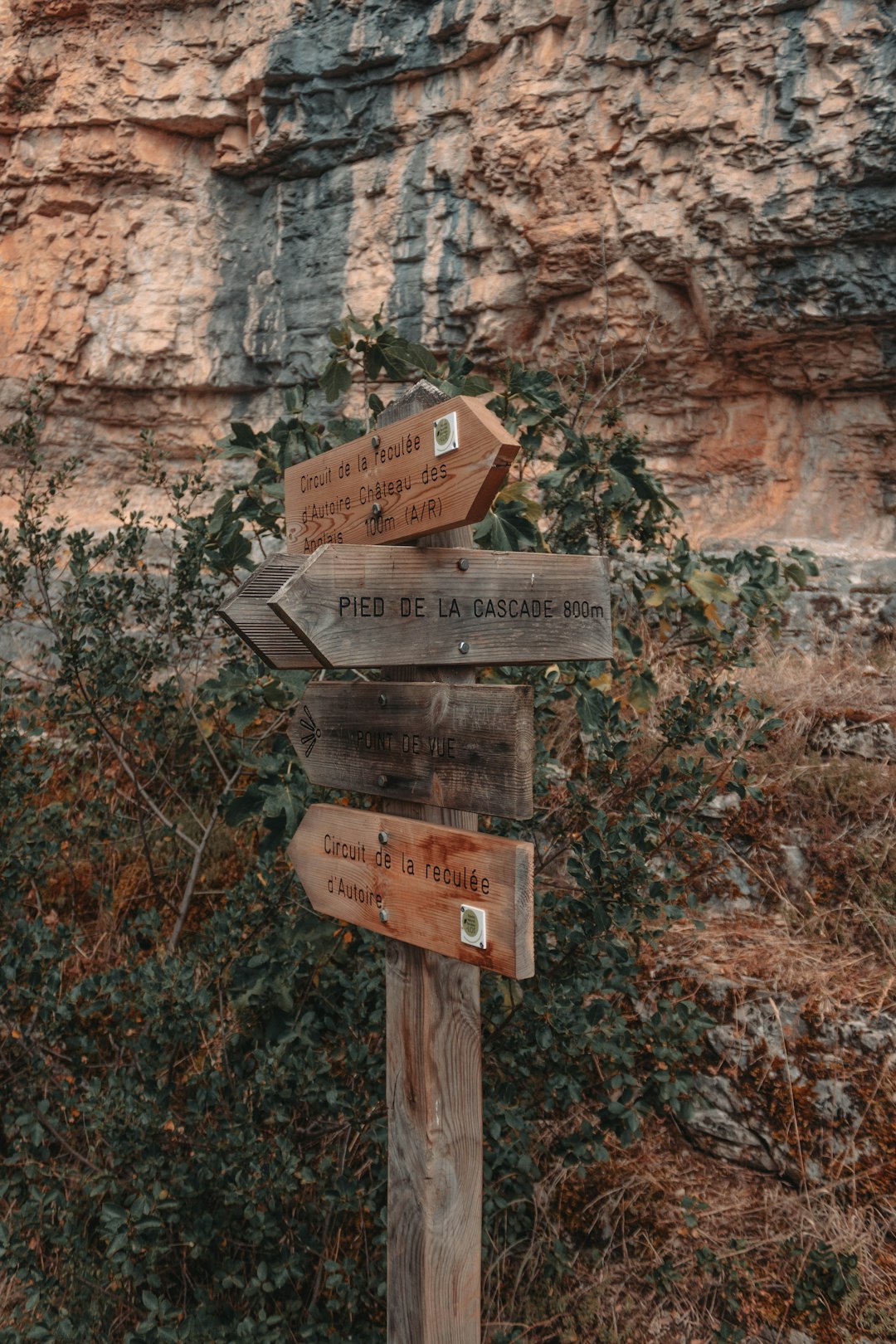 brown wooden signage on brown rock