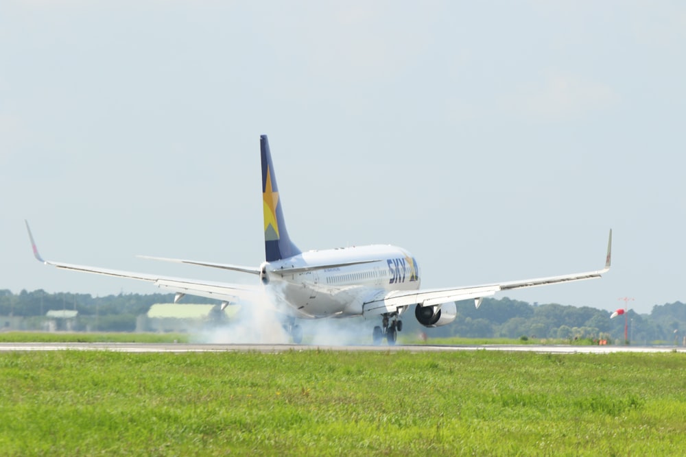 white and blue passenger plane on the air during daytime