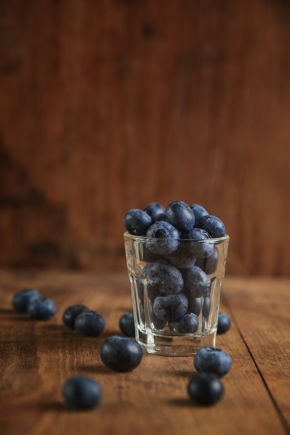 black berries in clear shot glass