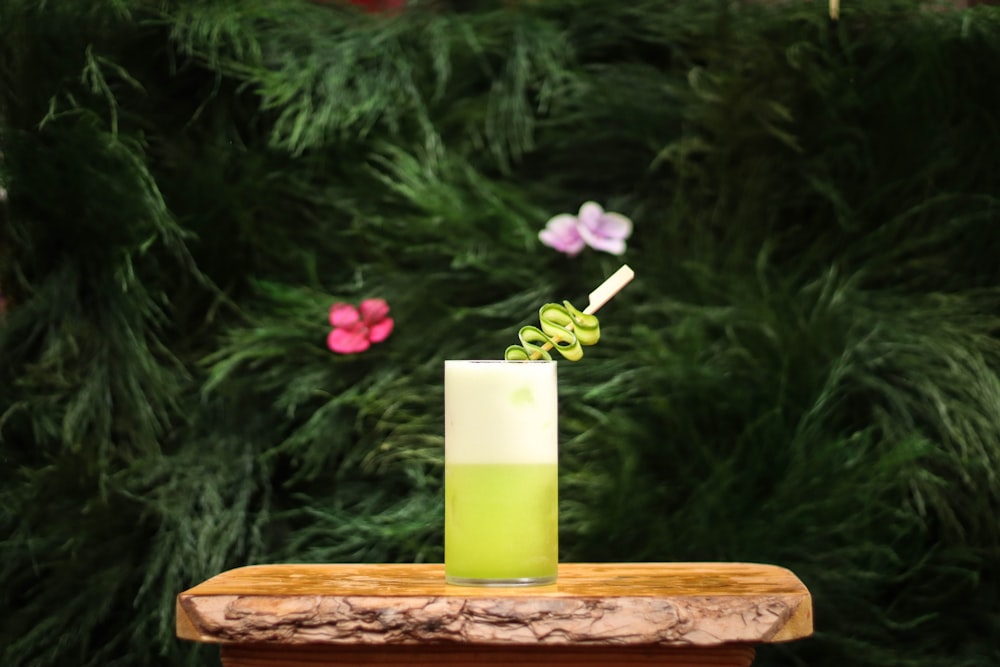 yellow pillar candle on brown wooden tray