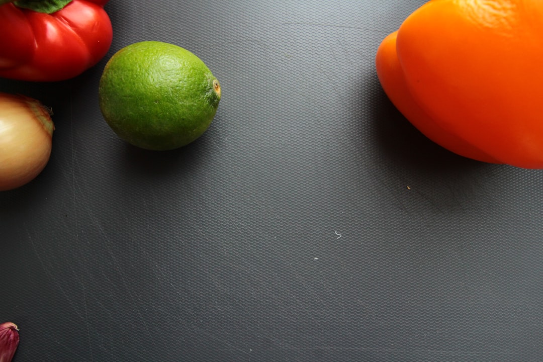 green and orange round fruit