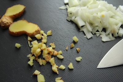 Fresh ginger and red onions arranged on a wooden crate ready for shipment.