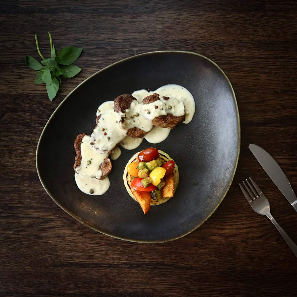 stainless steel fork on black ceramic plate