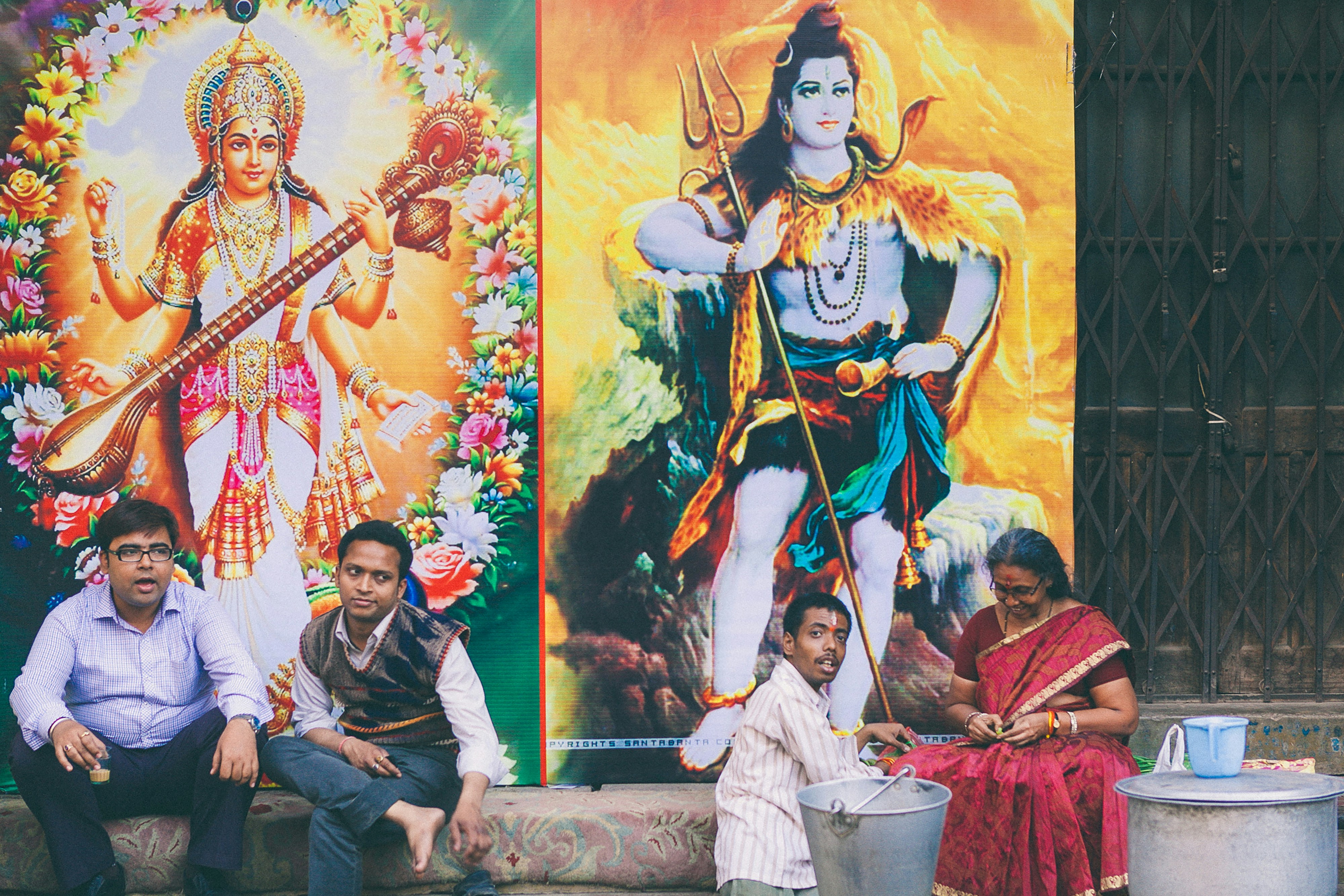 man in black jacket holding white bucket