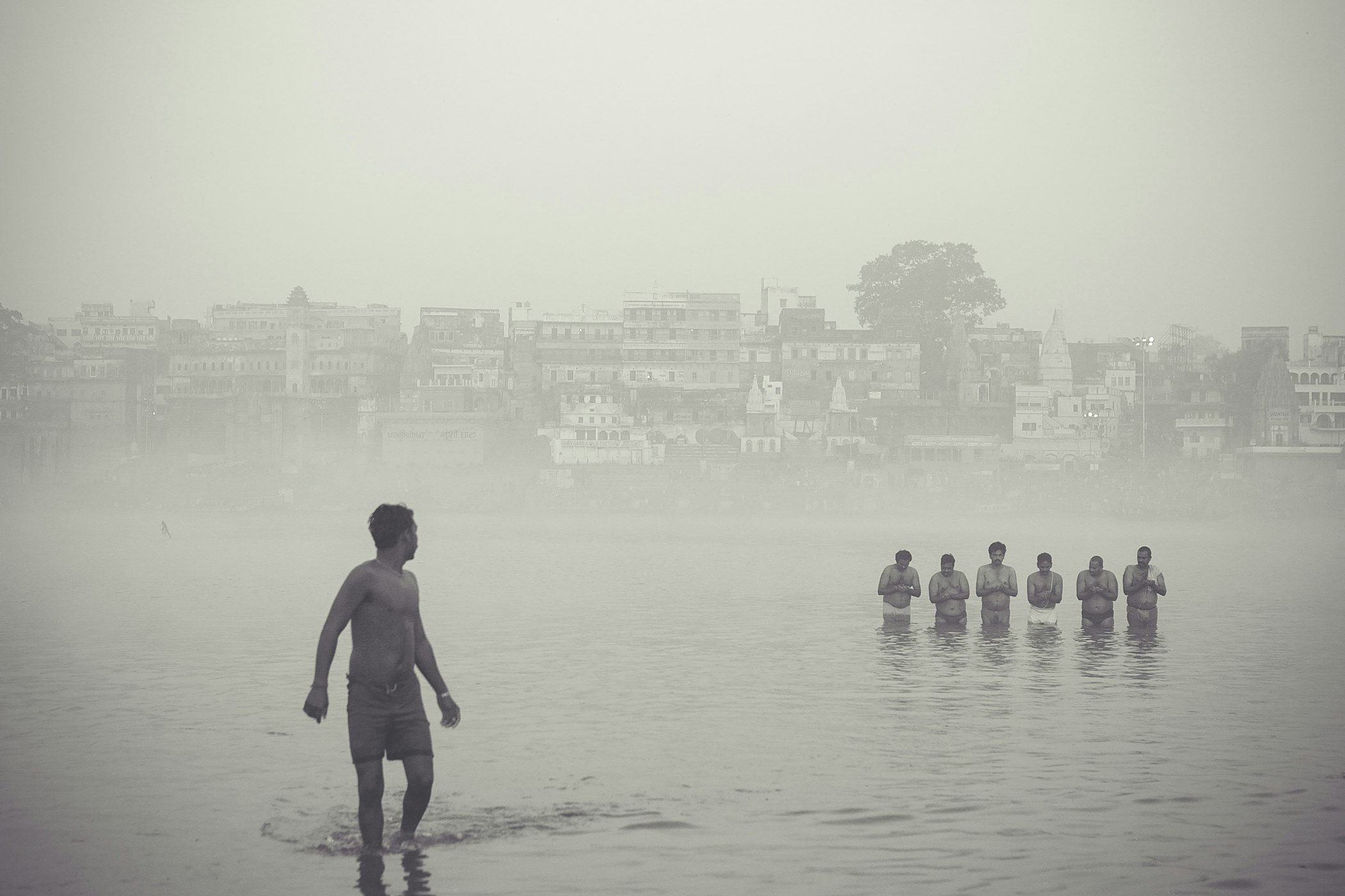 Individuals in the Ganges in Varanasi, India (Amit Guar via Unsplash)