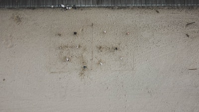 Close-up aerial shot of a beach volleyball match with players diving for the ball.