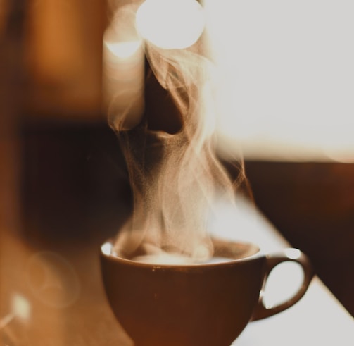 brown ceramic cup with white smoke