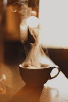 brown ceramic cup with white smoke
