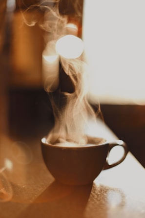 brown ceramic cup with white smoke
