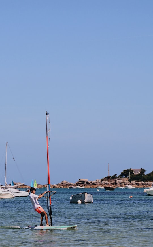 white and blue boat on sea during daytime in Brignogan-Plage France