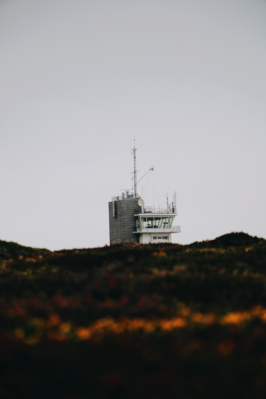 white concrete building on top of hill