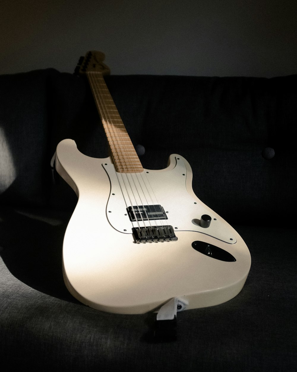 white and black stratocaster electric guitar