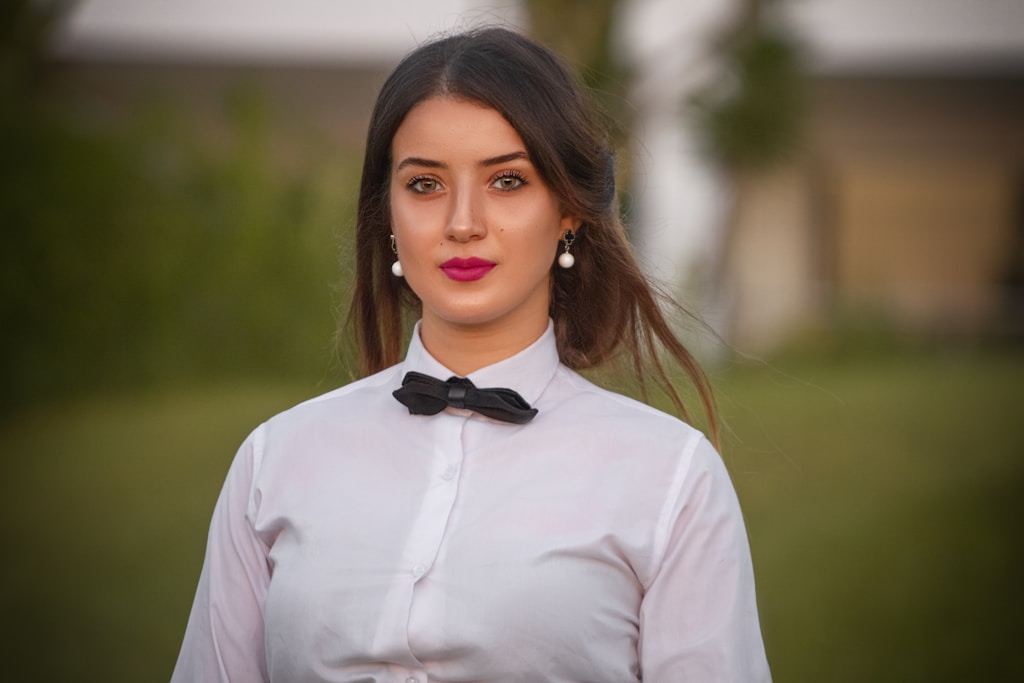 woman in white dress shirt and black bowtie