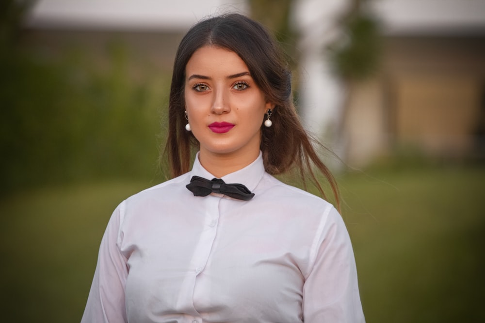 woman in white dress shirt and black bowtie