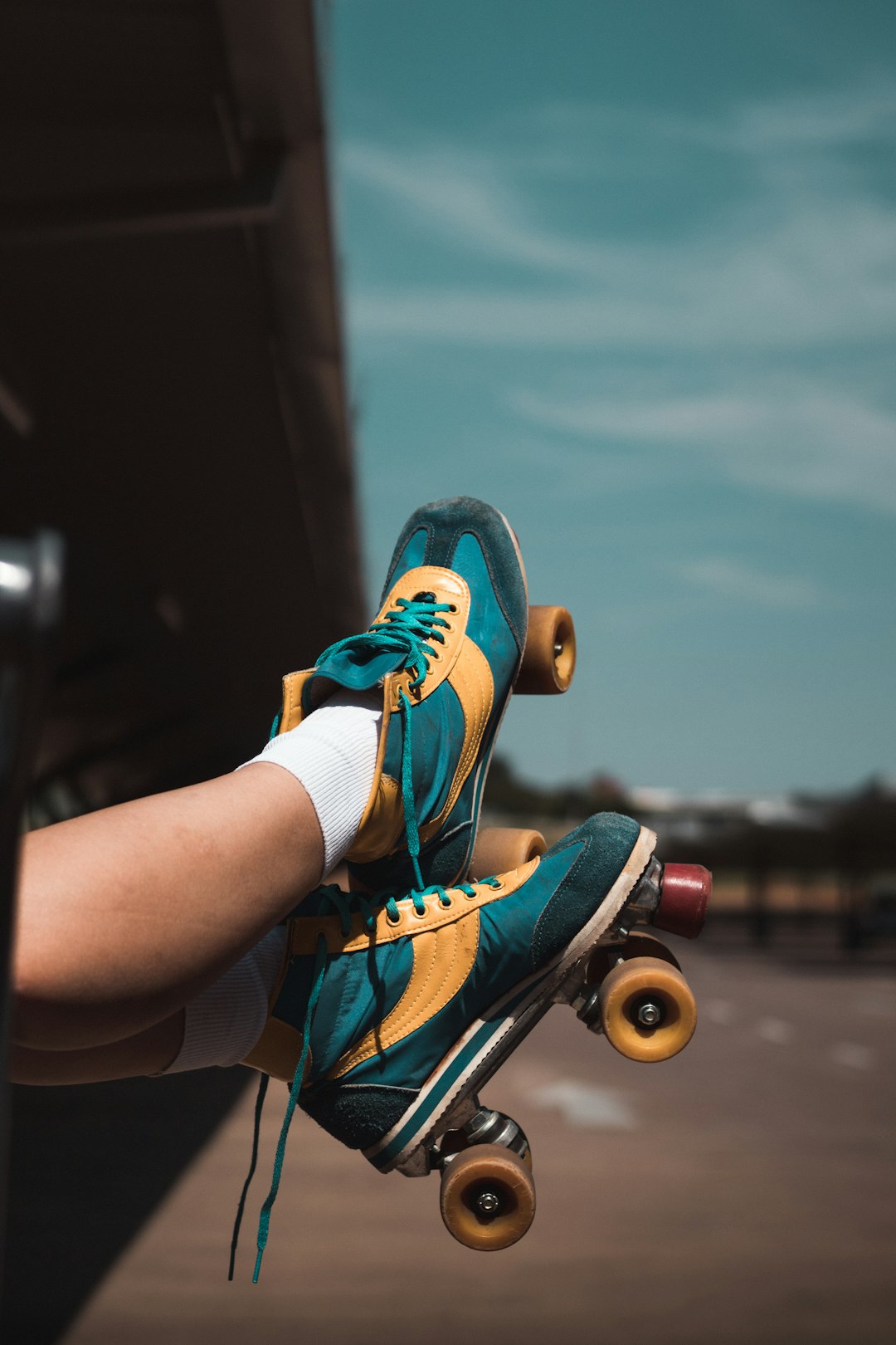 person wearing blue and orange nike athletic shoes