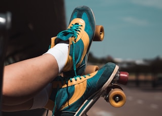 person wearing blue and orange nike athletic shoes