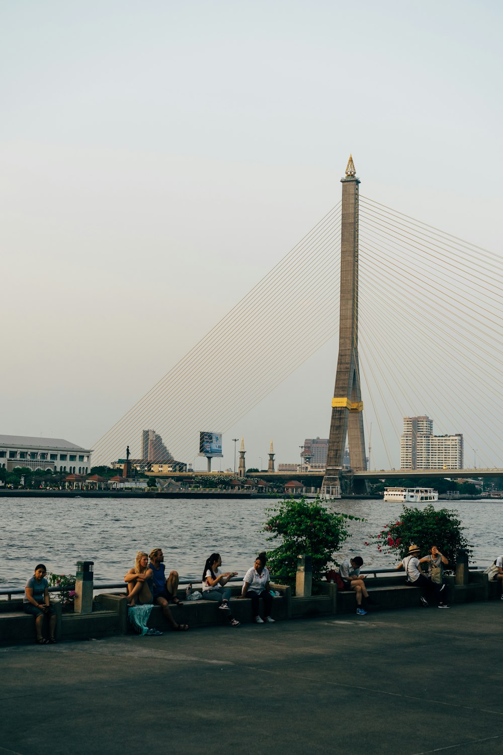 people sitting on bench near body of water during daytime