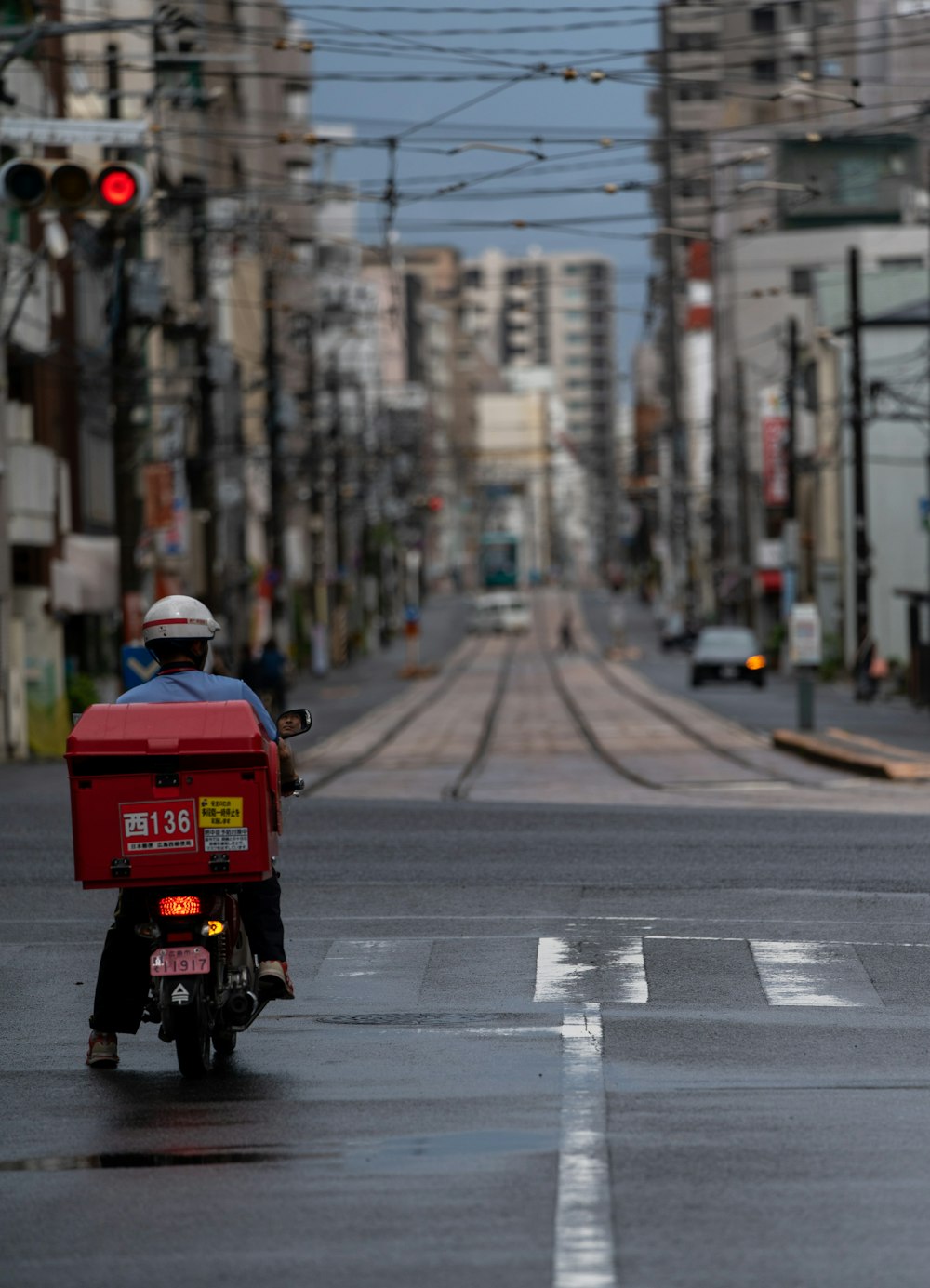 man in red jacket riding motorcycle on road during daytime