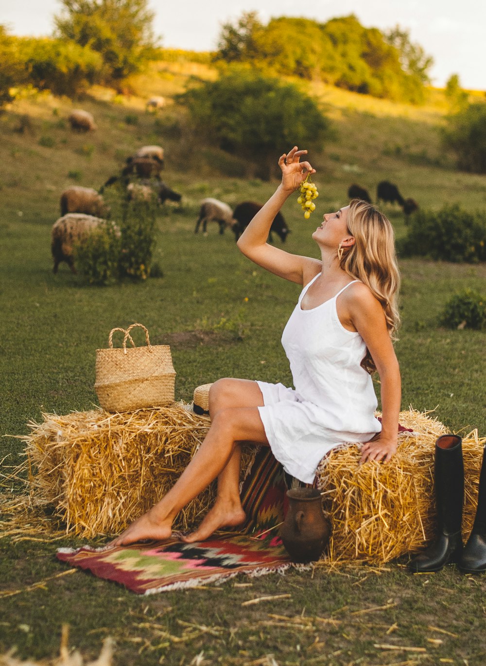 woman in white tank top sitting on brown hay