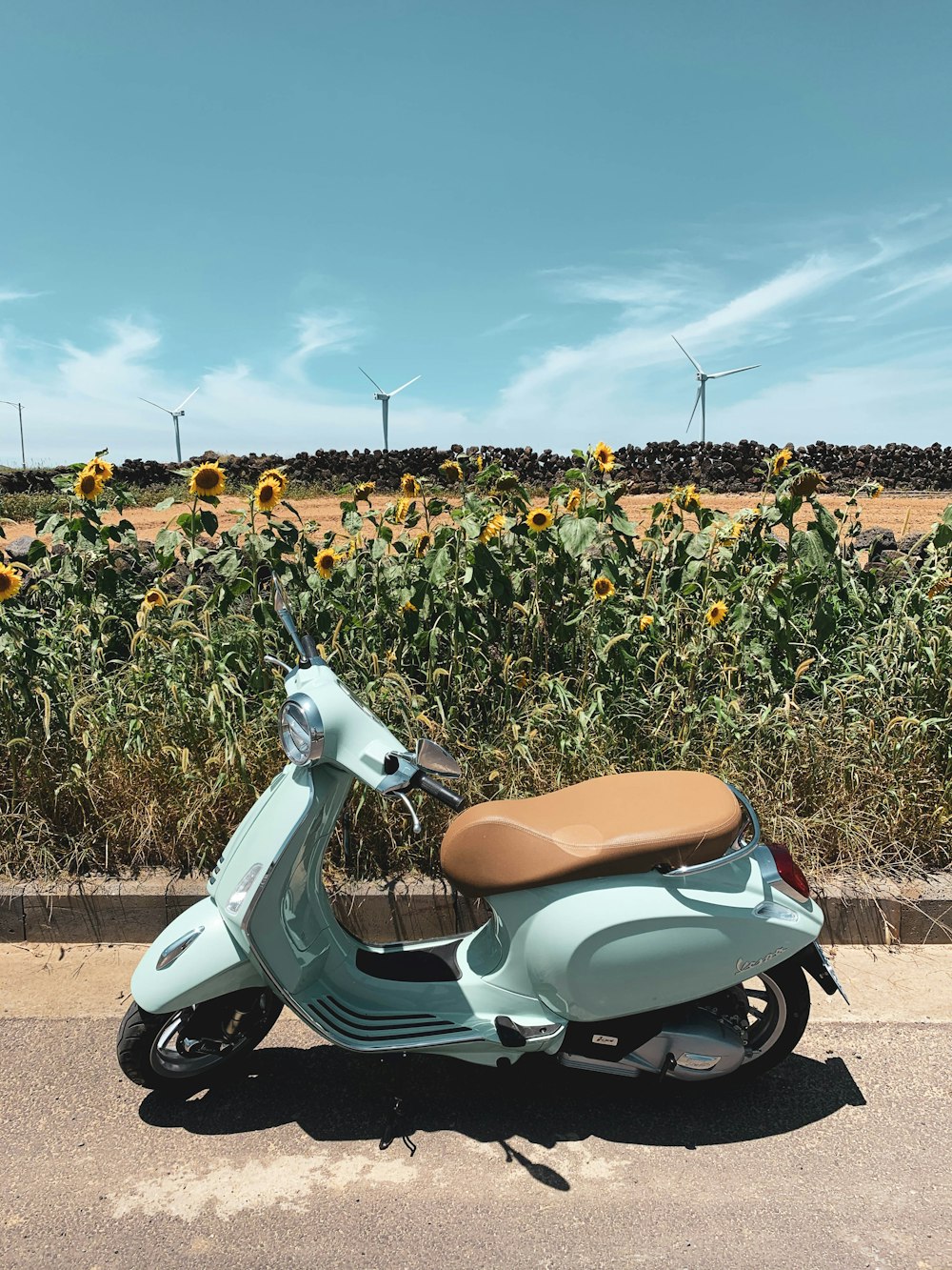 white and brown motor scooter on green grass field during daytime