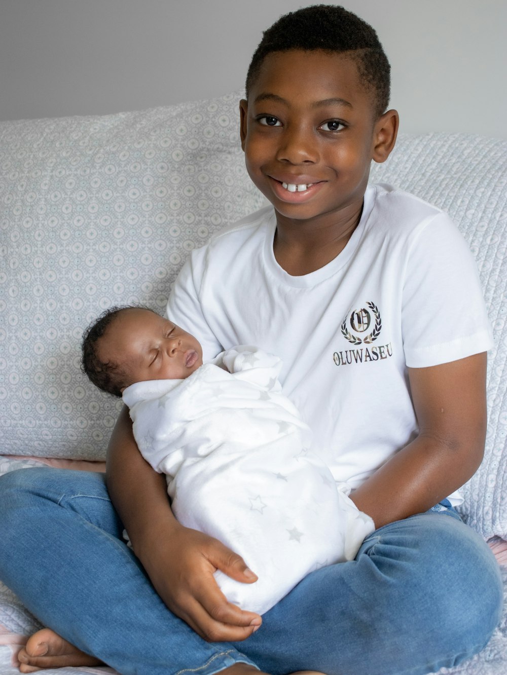 man in white crew neck t-shirt carrying baby