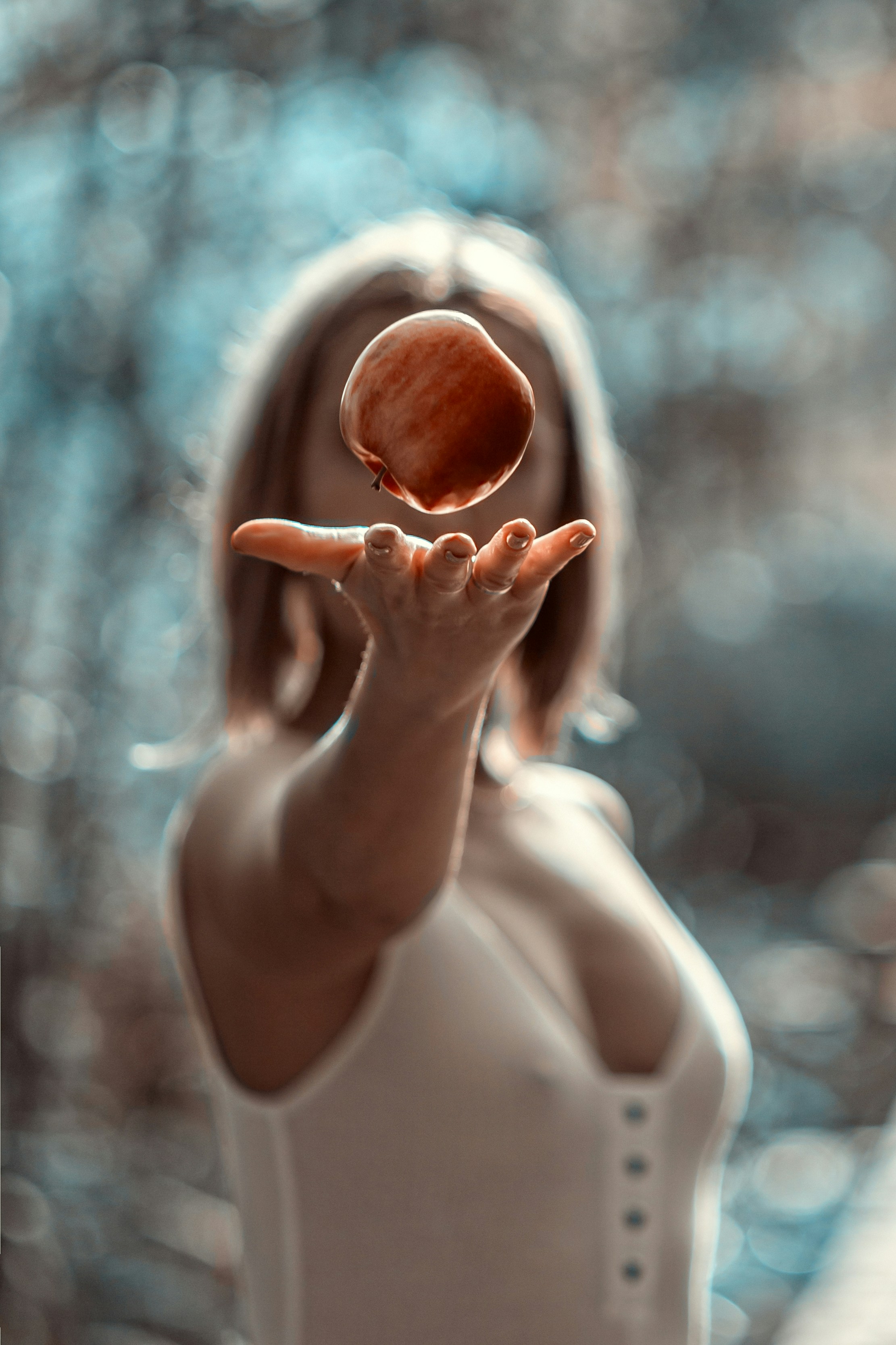 woman in white tank top holding heart shaped brown egg