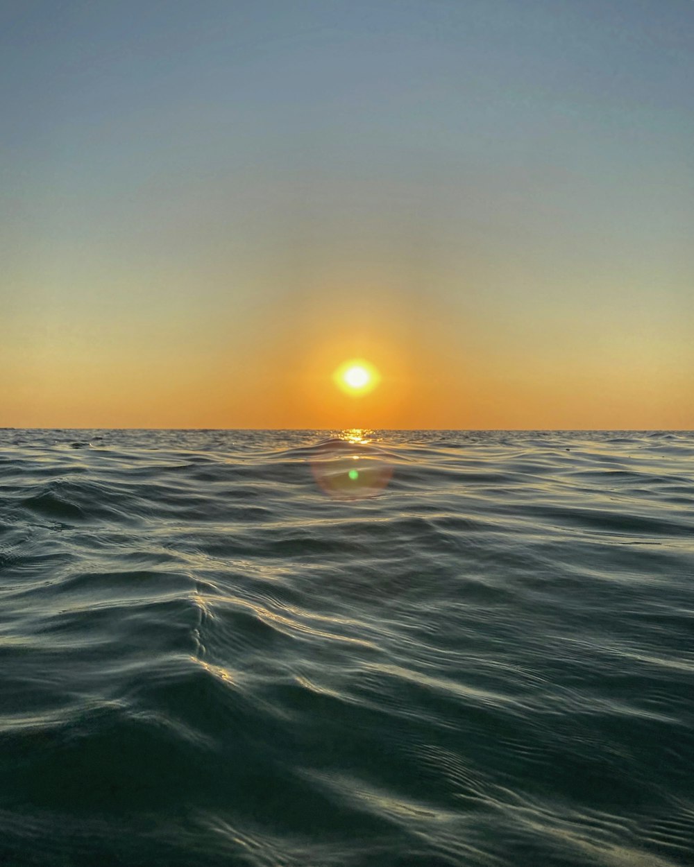 body of water during sunset