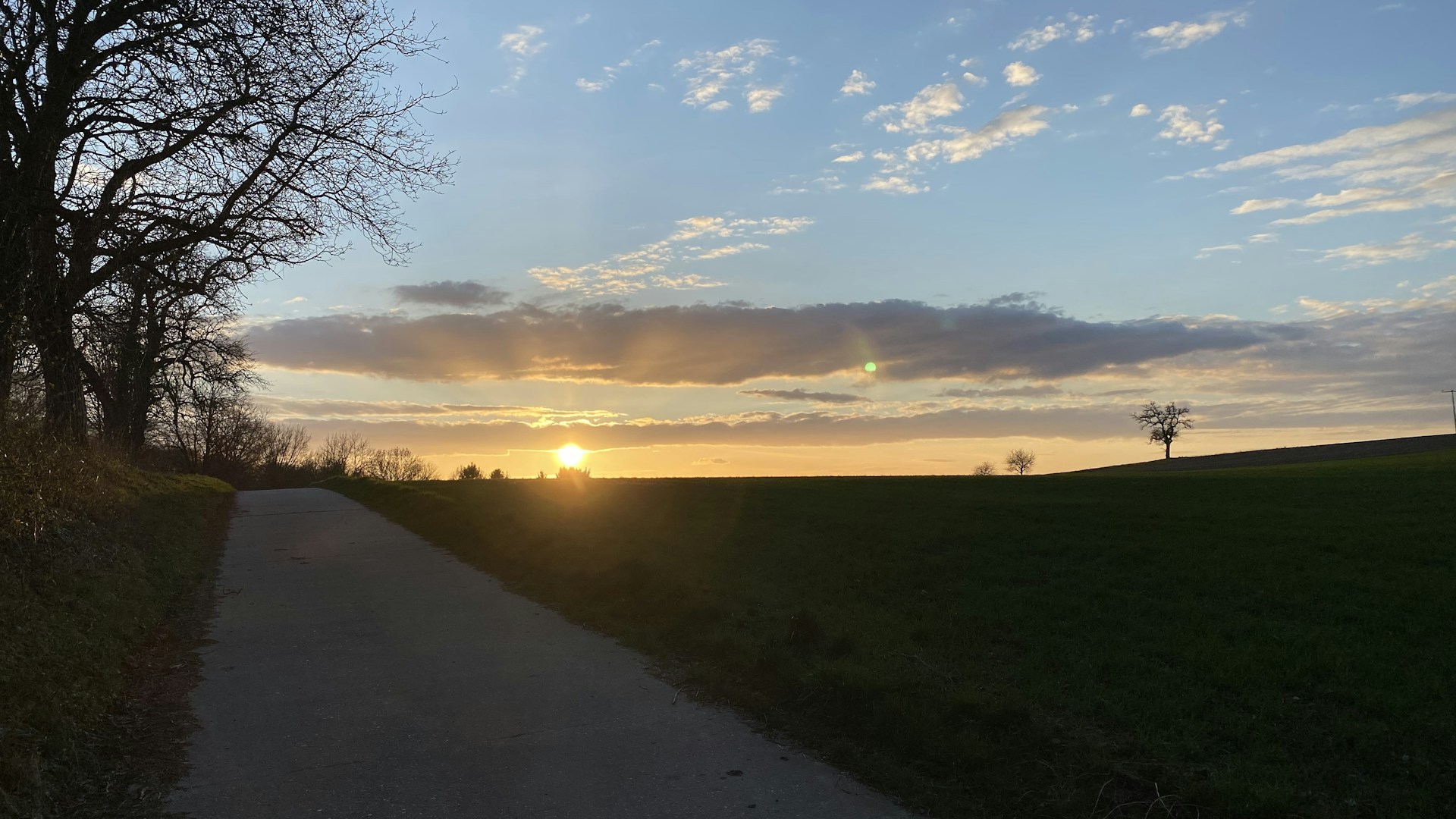 woman wearing yellow long-sleeved dress under white clouds and blue sky during daytime
