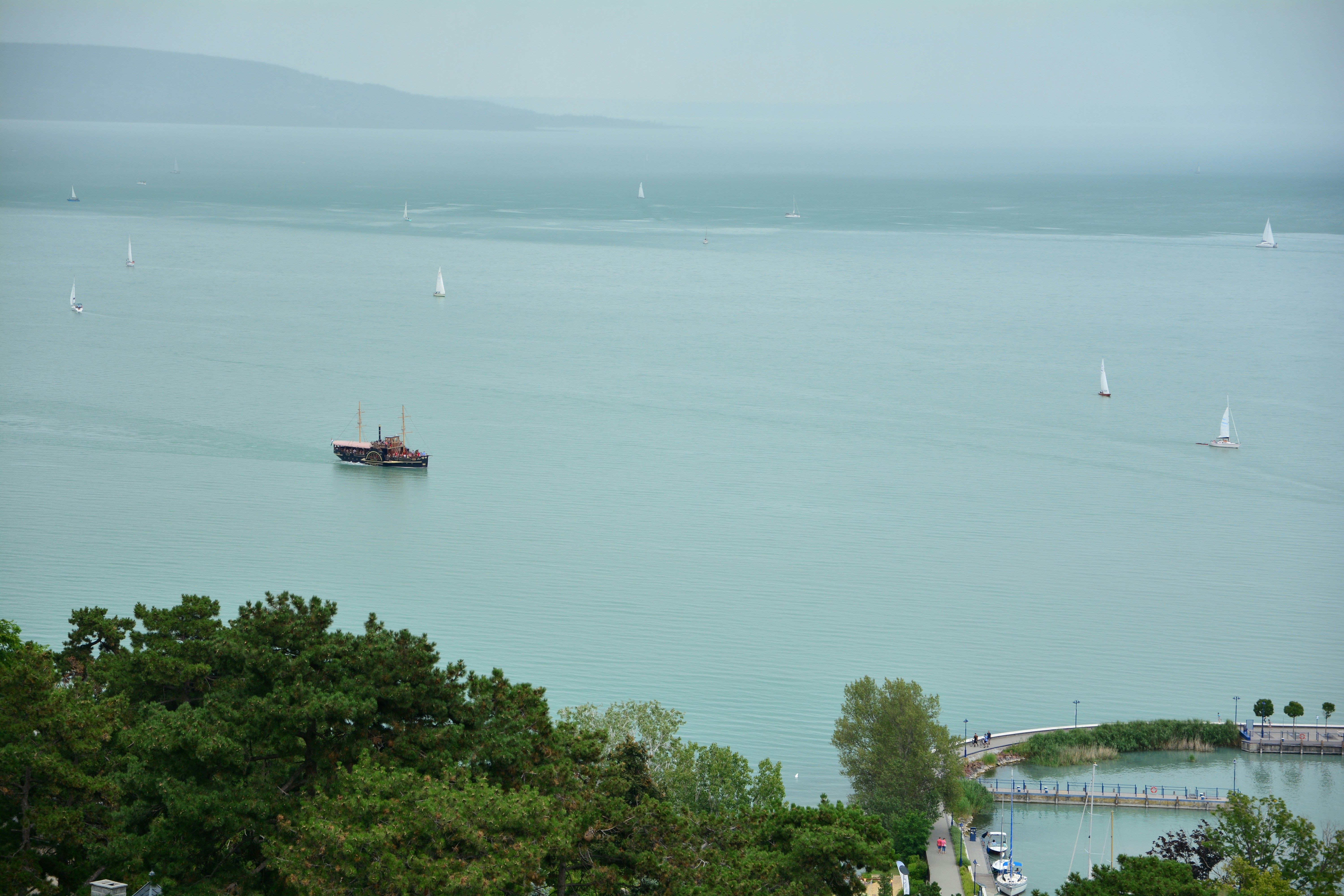 red boat on body of water during daytime