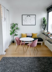 white and pink round table beside white wall